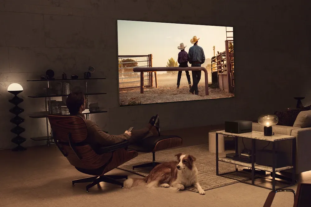 A person watching content on LG's new wireless smart TV.
