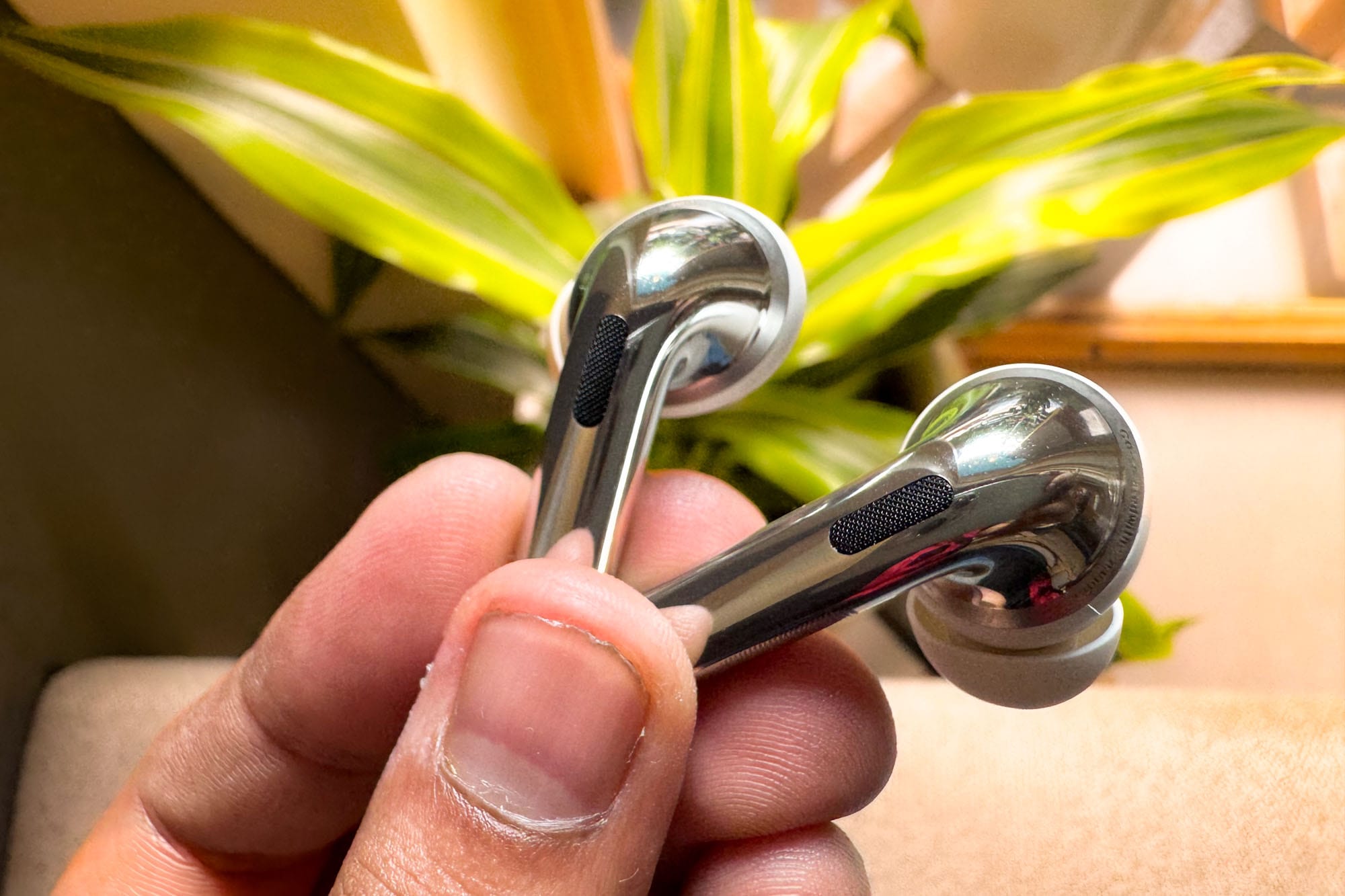 OnePlus Buds Pro 3 wireless earbuds in the hands of a person. 