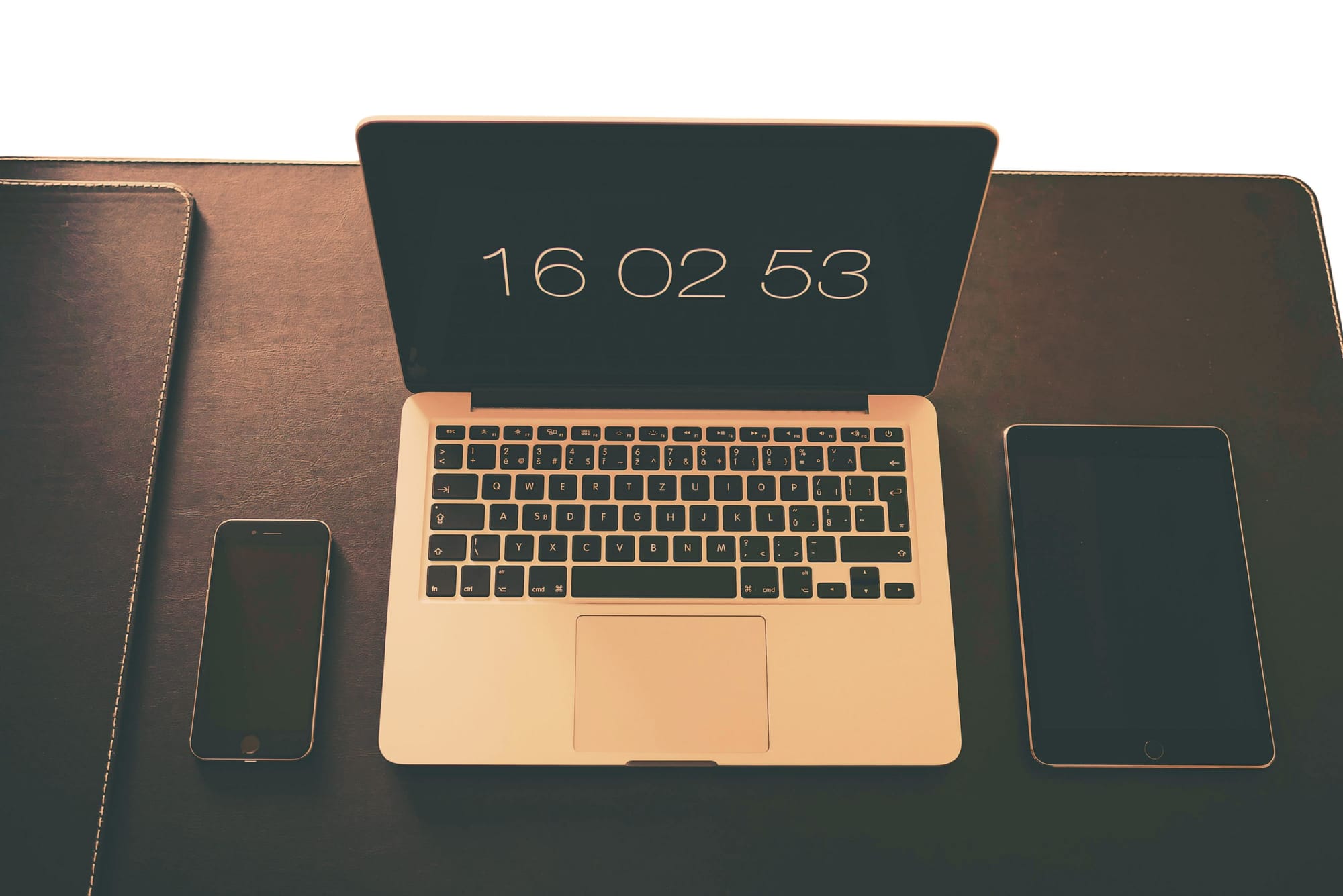 MacBook Pro, iPad, iPhone on table