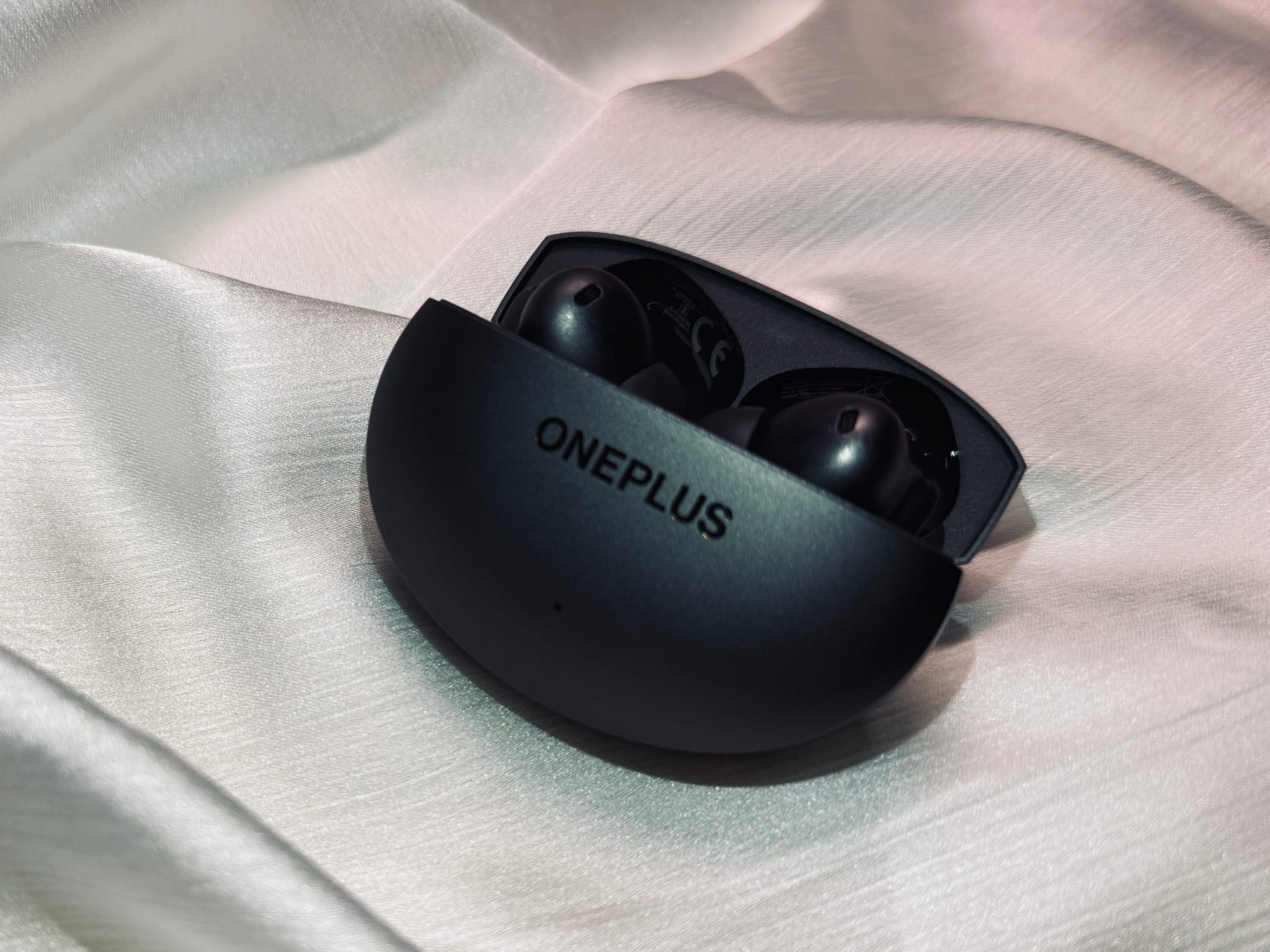 OnePlus Buds 4 earbuds with lid open