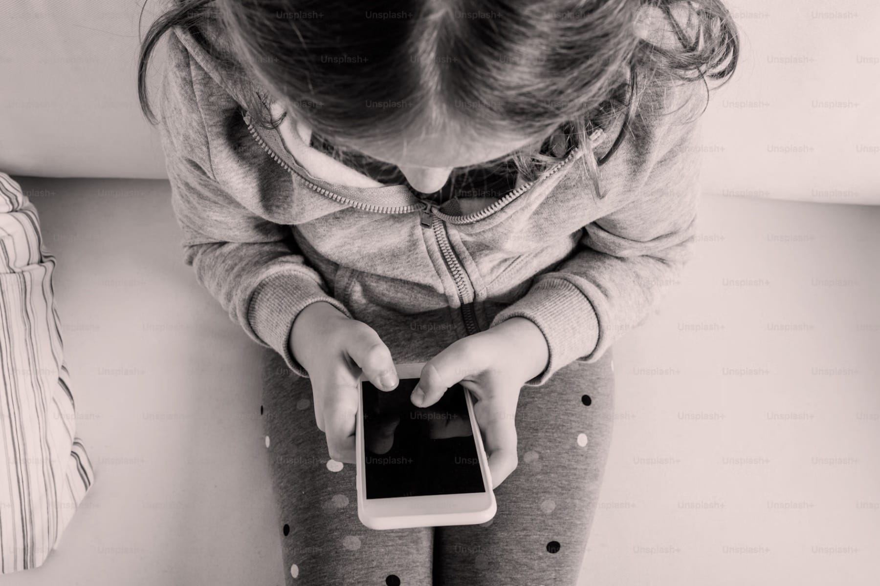Top view of a child using a phone.