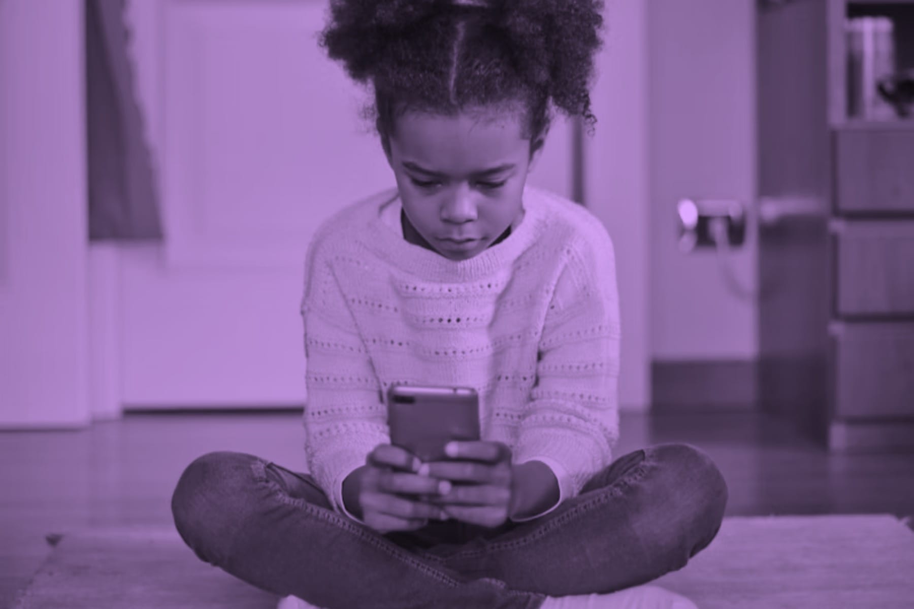Little girl using a phone.