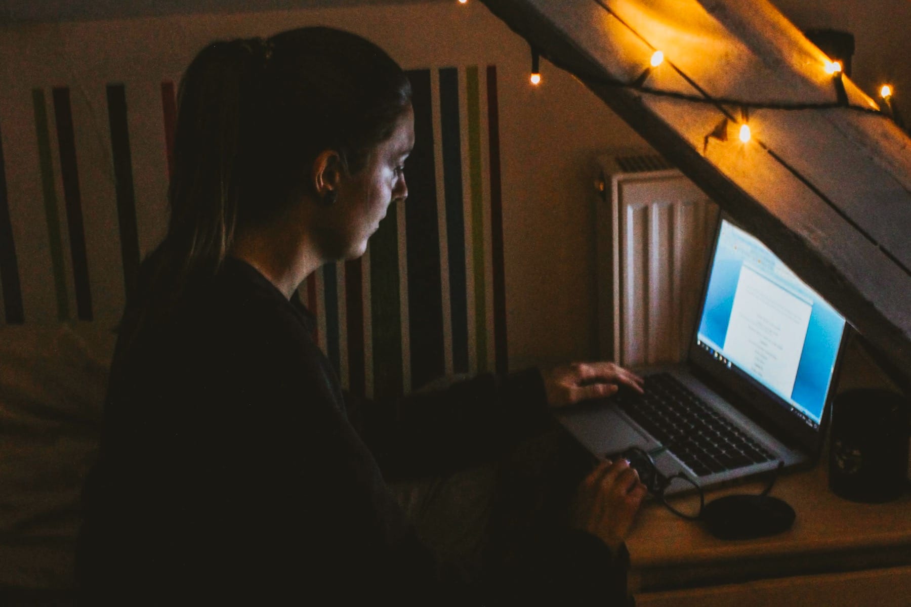 Woman using a laptop on her table.
