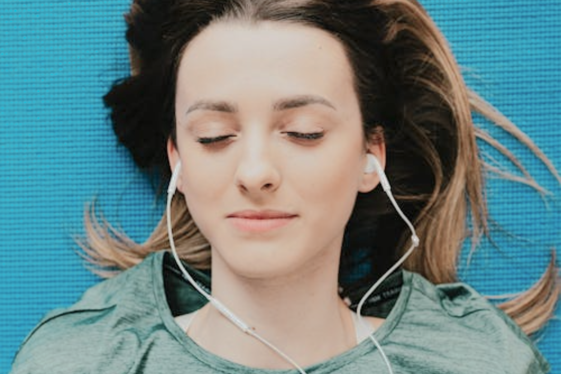 Woman listening to music on headphones.