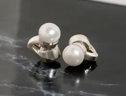These pearl earrings are actually open-ear speakers