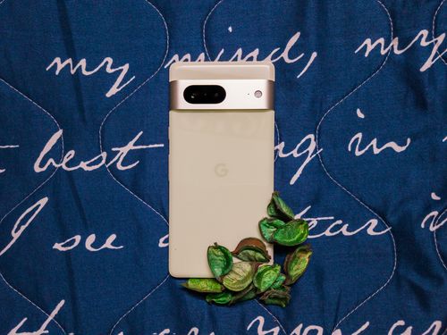 Google Pixel 7 in Lemongrass on a blue printed background. 