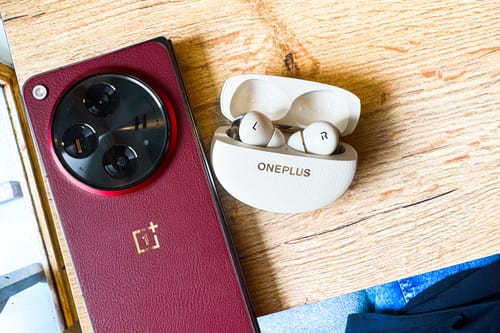 OnePlus Buds Pro 3 wireless earbuds with a OnePlus Open on a table.