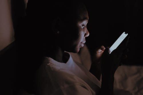 Person using a phone at night