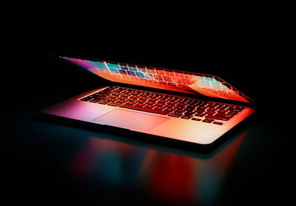 MacBook Pro with its lid halfway closed.