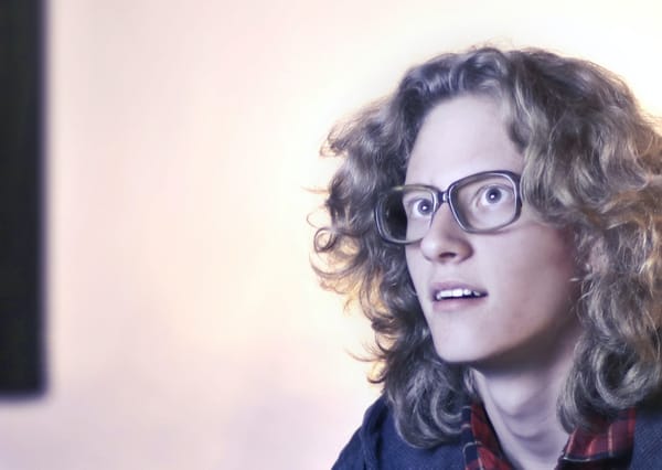 Woman wearing glasses staring at a screen