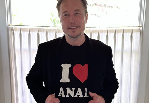 Elon Musk smiling at the camera.